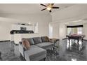 Open concept living area with stylish black marble floors, a comfortable couch, and a pool table at 3926 Ventura Place, Orlando, FL 32822