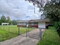 Traditional single story home featuring a fenced front yard and attached garage at 4225 Ne 25Th Ave, Ocala, FL 34479