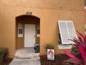 Close up of the home entrance, with a well-lit doorway and a charming 'welcome' sign at 4778 Vero Beach Pl, Kissimmee, FL 34746