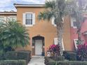 Attractive two-story townhome with a well-maintained facade, lush plants, and lovely curb appeal at 4778 Vero Beach Pl, Kissimmee, FL 34746