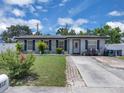 Well-maintained front yard with lush green grass, mature landscaping, and a brick-lined driveway at 517 Ivanhoe Way, Casselberry, FL 32707