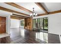 Spacious living room featuring hardwood floors, exposed wood beams, and lots of natural light at 5301 Burning Tree Dr # F, Orlando, FL 32811