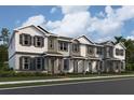 Beautiful three-story townhomes showcasing varied exterior paint schemes and charming architectural details in a modern neighborhood at 551 Pothos St, Apopka, FL 32703