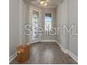 An empty foyer is illuminated by a hanging light fixture at 5550 Sabal Dr, St Cloud, FL 34771