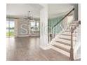 A staircase leads into the naturally lit living room at 5550 Sabal Dr, St Cloud, FL 34771