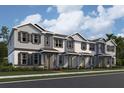 New townhome construction featuring varied siding, decorative shutters, and covered entryways with stone accents at 559 Pothos St, Apopka, FL 32703