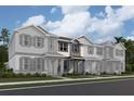 New townhome construction featuring varied siding, decorative shutters, and covered entryways with stone accents at 559 Pothos St, Apopka, FL 32703