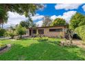 Spacious backyard with lush green grass, perfect for outdoor activities and relaxation at 5604 Astoria Pl, Orlando, FL 32808
