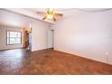 Bright living room featuring parquet floors, a ceiling fan, and plenty of natural light at 5604 Astoria Pl, Orlando, FL 32808