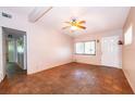 Inviting living room showcasing a front door, large window, and classic parquet flooring at 5604 Astoria Pl, Orlando, FL 32808
