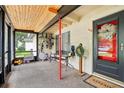 View of the screened porch with a wood ceiling, front door, seating, and a wall-mounted bike rack at 618 Acapulca Way, Altamonte Springs, FL 32714