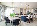 Open-concept dining room featuring modern lighting and a view into a stylish kitchen at 842 Creeping Fig St, Apopka, FL 32703