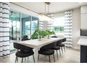 Bright dining area with sliding glass doors leading to outdoor space and stylish decor at 842 Creeping Fig St, Apopka, FL 32703