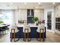 Modern kitchen with a large island, pendant lighting, and counter seating for casual dining at 842 Creeping Fig St, Apopka, FL 32703