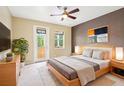Cozy bedroom with balcony, neutral decor, large windows, and modern furnishings at 8430 Leatherleaf Ln, Orlando, FL 32827