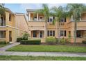 Attractive two-story home with tropical landscaping, well-manicured lawn, and a charming facade at 8430 Leatherleaf Ln, Orlando, FL 32827