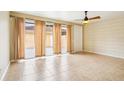 Bright living room with tile floors, ceiling fan, and sliding glass doors that lead to the patio at 8430 Leatherleaf Ln, Orlando, FL 32827