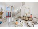 Bright and airy living room featuring high ceilings, marble floors, and elegant decor at 9062 Dancy Tree Ct, Orlando, FL 32836
