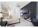 Stylish main bedroom features a modern built-in cabinet and shelving, and a plush bed at 9062 Dancy Tree Ct, Orlando, FL 32836