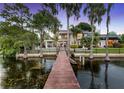 Expansive backyard view with a pool, private dock, and access to the tranquil waterfront at 9146 Bay Point Dr, Orlando, FL 32819