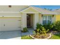 Close up of a single Gathering home with a two-car garage, lawn, and attractive landscaping at 984 Chanler Dr, Haines City, FL 33844