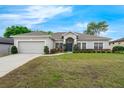 Charming home exterior with a green lawn, manicured bushes, and a cozy, welcoming front entrance at 3956 Shadowind Way, Gotha, FL 34734