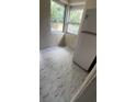 Compact kitchen features white linoleum flooring, and a white refrigerator at 1030 Nw 13Th Ave, Ocala, FL 34475