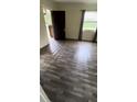 Bright living room featuring dark laminate flooring, a window, and neutral paint at 1030 Nw 13Th Ave, Ocala, FL 34475