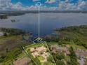 Aerial view showcasing the home's location on a large lot near the lake at 11103 Bridge House Rd, Windermere, FL 34786