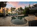 Sparkling swimming pool with a lush tropical landscape and lake views providing a resort-like atmosphere at 11103 Bridge House Rd, Windermere, FL 34786