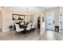 Formal dining room featuring hardwood floors, elegant lighting, and stylish decor at 1154 Kerwood Cir, Oviedo, FL 32765