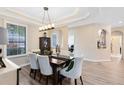 Formal dining room featuring hardwood floors, elegant lighting, and stylish decor at 1154 Kerwood Cir, Oviedo, FL 32765