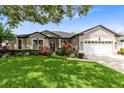 Charming single-story home with a well-manicured lawn and mature landscaping at 1154 Kerwood Cir, Oviedo, FL 32765