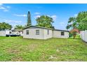 Expansive backyard featuring a lush green lawn and perimeter trees, offering ample space at 1170 E Bay St, Winter Garden, FL 34787