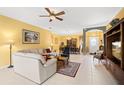 Open-concept living room with tile floors, bright yellow walls, and plenty of natural light at 118 Ventana Dr, Kissimmee, FL 34759