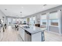 Bright kitchen island with granite countertops flows into the dining and living areas with ample windows at 13334 Beebe Aly, Orlando, FL 32827