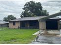 Charming single-story home featuring carport, lush lawn, and inviting curb appeal at 1335 Cr 442, Lake Panasoffkee, FL 33538