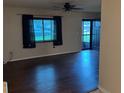 Inviting living room featuring hardwood floors, natural light, and an open entrance for easy access at 1335 Cr 442, Lake Panasoffkee, FL 33538