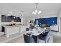 Bright and open living room with modern furnishings and dining table at 144 Williamson Dr, Davenport, FL 33897