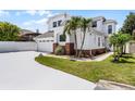 Two story home featuring an attached two car garage, neutral paint, decorative brick detail, and tropical landscaping at 14423 Tambourine Dr, Orlando, FL 32837