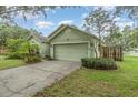 Charming single-story home featuring a two-car garage and manicured landscaping at 16103 Denham Ct, Clermont, FL 34711