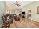 Spacious living room featuring wood floors, modern furniture, and an open floor plan at 16103 Denham Ct, Clermont, FL 34711