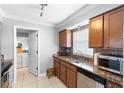 Well-lit kitchen boasts granite countertops, stainless steel appliances, and modern finishes at 1647 Crestlawn Ave, Orlando, FL 32811