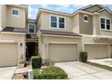 A beautiful townhome with a well-kept lawn, an attached garage, and lovely curb appeal at 178 Windflower Way, Oviedo, FL 32765
