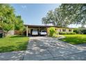 Inviting single-Gathering home featuring a spacious carport and lush green lawn at 1901 Loch Berry Rd, Winter Park, FL 32792