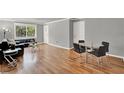 Open-concept living room with hardwood floors, dining area, and large window at 1940 S Conway Rd # 8, Orlando, FL 32812