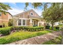 Charming home featuring a landscaped front yard, inviting entrance, and exterior with a modern color palette at 2246 Florida Soapberry Blvd, Orlando, FL 32828