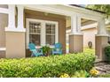 Cozy front porch seating, with an inviting spot to relax, framed by lush landscaping at 2246 Florida Soapberry Blvd, Orlando, FL 32828
