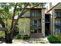 Condominium exterior showcasing balconies, a red roof, and verdant landscaping for inviting curb appeal at 234 Afton Sq # 305, Altamonte Springs, FL 32714