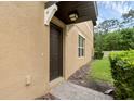 Exterior close up showing front door, stucco, and walkway at 2502 Seven Oaks Dr, St Cloud, FL 34772
